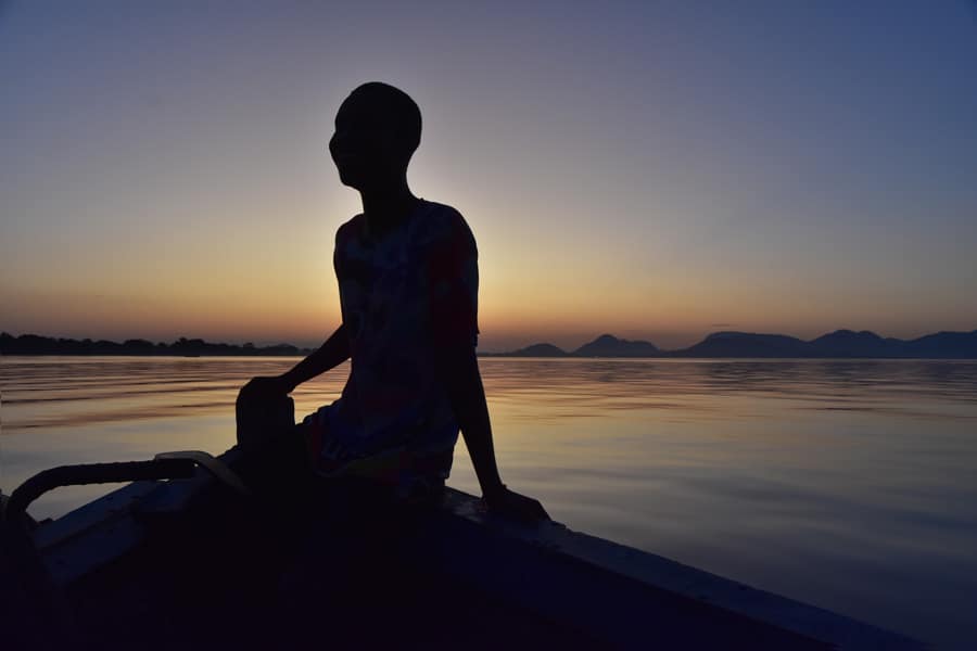 boat ride back to base as the sun disappears behind the hills